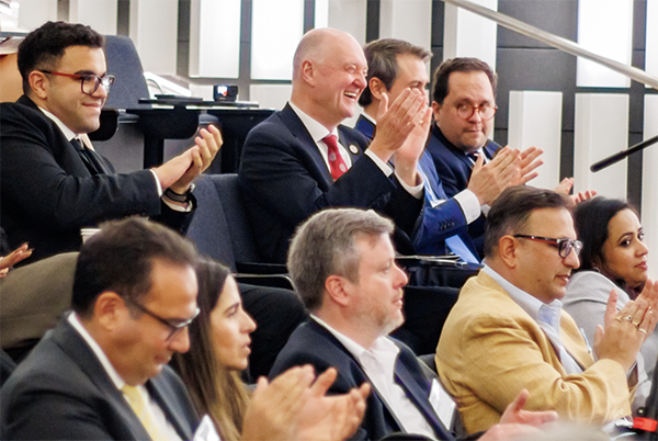 Attendees at the 2024 EMI conference, including Dean Karolyi, applaud case competition winners.