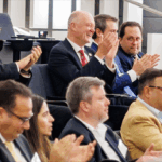 Attendees at the 2024 EMI conference, including Dean Karolyi, applaud case competition winners.