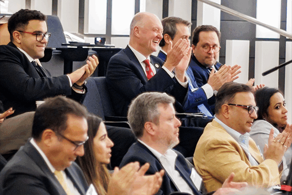 Attendees at the 2024 EMI conference, including Dean Karolyi, applaud case competition winners.