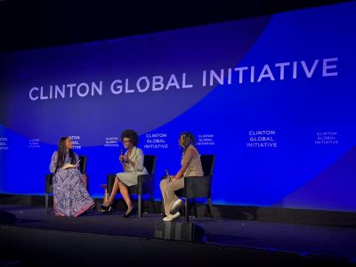 Lydiah Bosire speaking on a panel of three individuals at the Clinton Global Initiative