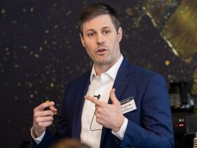 Action shot of Rob Collier speaking and gesturing