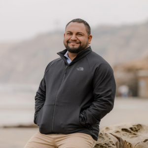 Teevrat Garg stands on a beach on an overcast day.