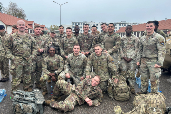 Brandon Jones, MBA ’27, with military colleagues as part of a NATO battle group in Poland.