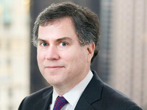 A headshot of Alan Kanders in businesswear.