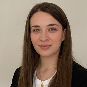 Sarah Callaghan in front of a beige backdrop