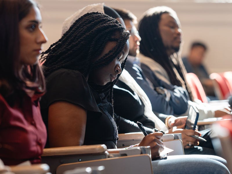 Student taking notes in class