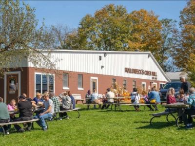 Hollenbeck’s Cider Mill storefront with customers enjoying products