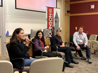 Tess Williams answering a question posed by Brian Bauer, who is moderating a panel that also includes Tess Williams, Sarah Mousa and Eleanor Glenn.