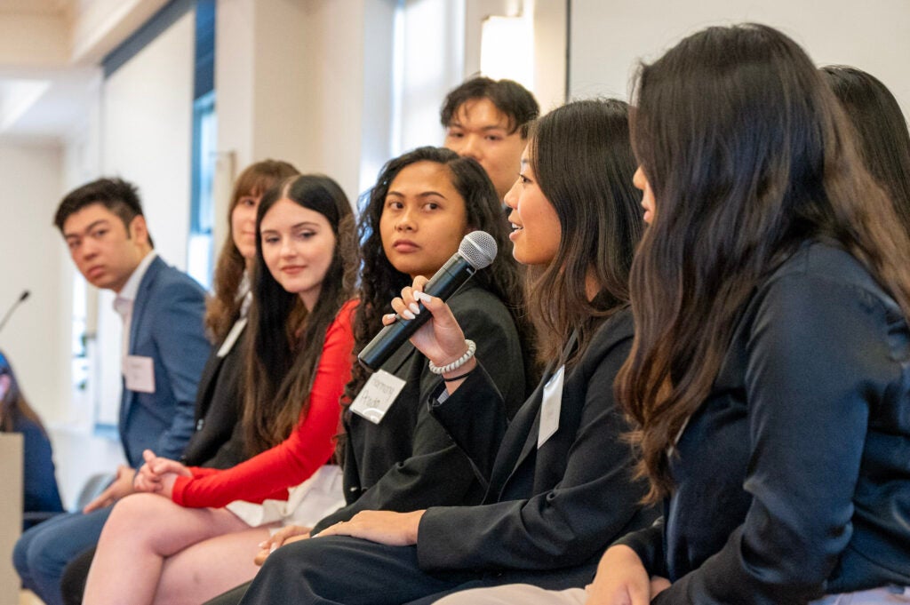 Students at a panel discussion with alumni and corporate partners
