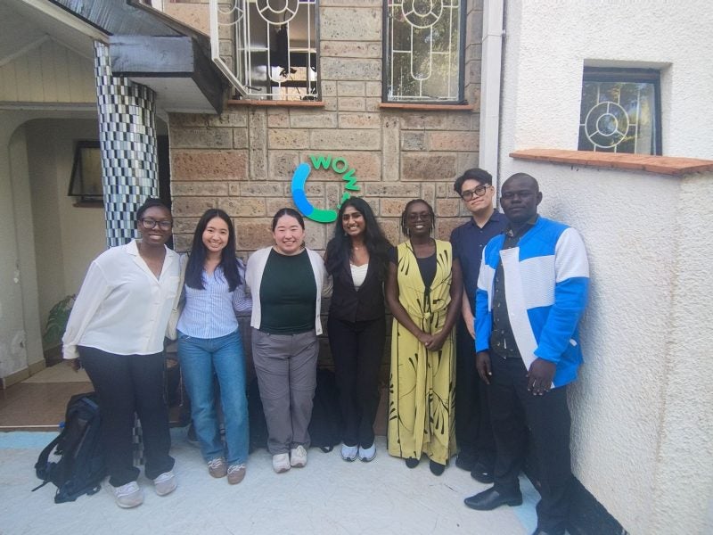 Students stand in front of Wowzi offices in Kenya.