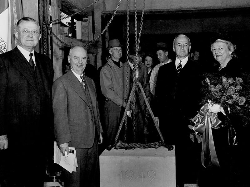 A group of four men pose with Alice Statler as the cornerstone is laid.