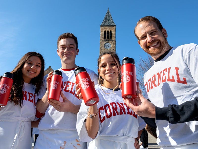 Nolan students holding "hotelie" water jugs at Derby Day
