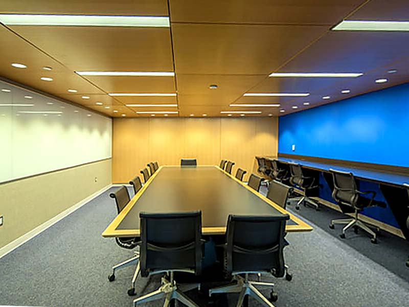 Club room, large rectangle table, ten chairs, more chairs at bench on side of wall