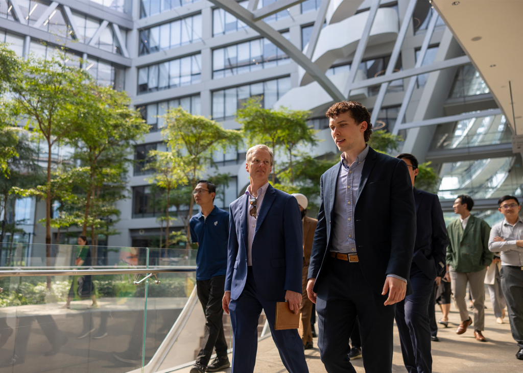 Real estate masters students walking through the streets of Singapore on a student trek for the program.