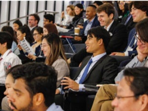 Audience at the conference interacting with the presentations