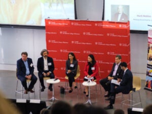Panelists Wim Vandenhoeck, Francesco Del Vecchio, Ana Gomez Chapman, Joyce Chang, Drausio Giacomelli, and Andres Suarez at the EMI Annual Conference, with a red Cornell banner behind them.