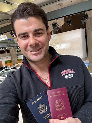 Image of Guzzo at the Renaissance Center in Detroit, Michigan, where the Consulate of Italy is located, displaying two passports.