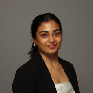 Prerana Reddy standing in front of a gray backdrop