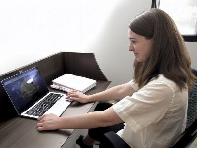Sarah Callaghan at her desk with her laptop open to Zymtronix&rsquo;s website