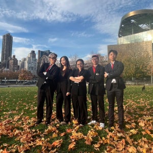 Vinception members outside the Bloomberg Center on the Cornell Tech campus with Manhattan buildings in the background.
