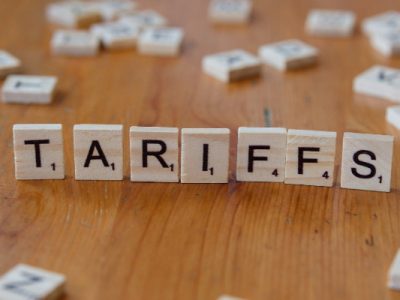 Scrabble tiles that spell the word "tariffs"