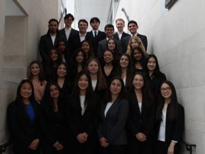 Students pose on the stairs.