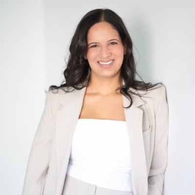 Professional photo of Melissa Linares in a beige suit and white shirt.