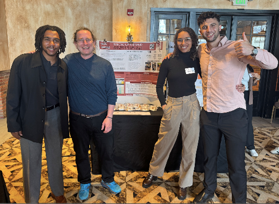 BRM team members pose with Olivia Carpenter of Via's Cookies.