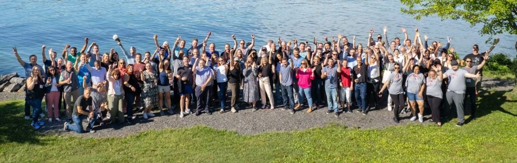 Food Executive Program participants pose on the edge of a lake.