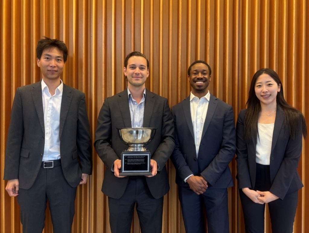 2026 Cayuga Fund Credit Research Challenge winning team posing against a wood wall.
