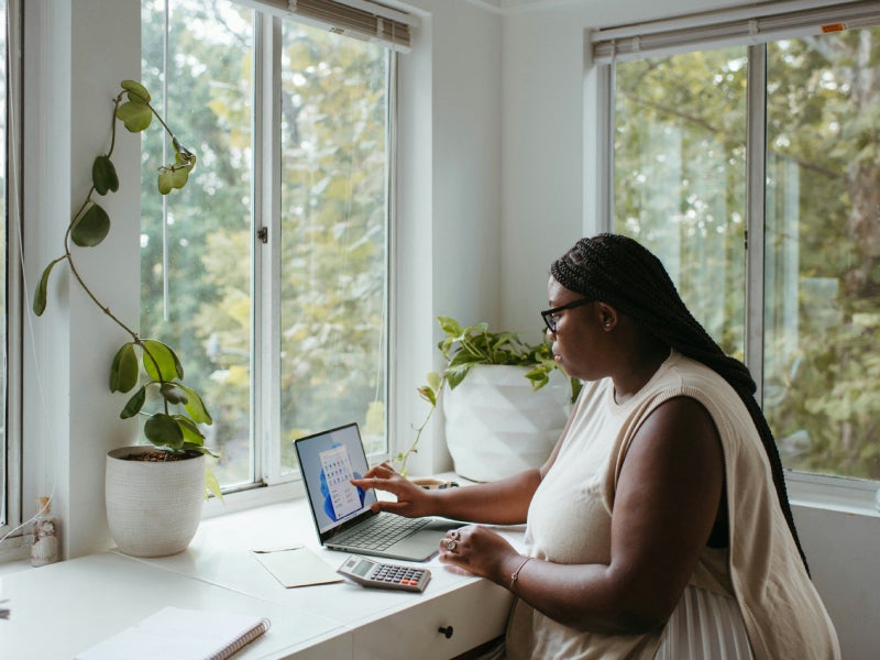 Woman sitting at a laptop computer.