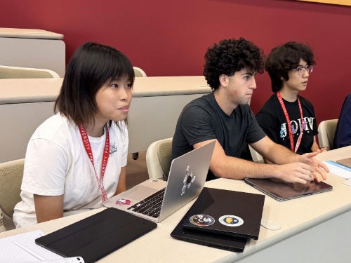 A group of high school students in a classroom.