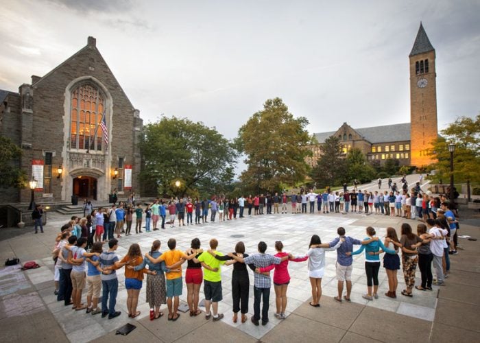 Students formed into large circle in front of clock tower