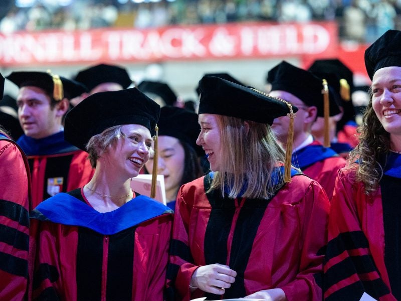 2 Ph.D. candidates ready to receive their diploma